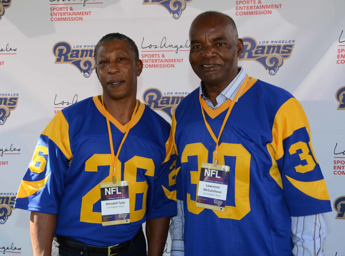 Former Rams running backs Wendell Tyler (26) and Lawrence McCutcheon (30) pose at an NFL All-Access event at the Los Angeles Memorial Coliseum in 2016.